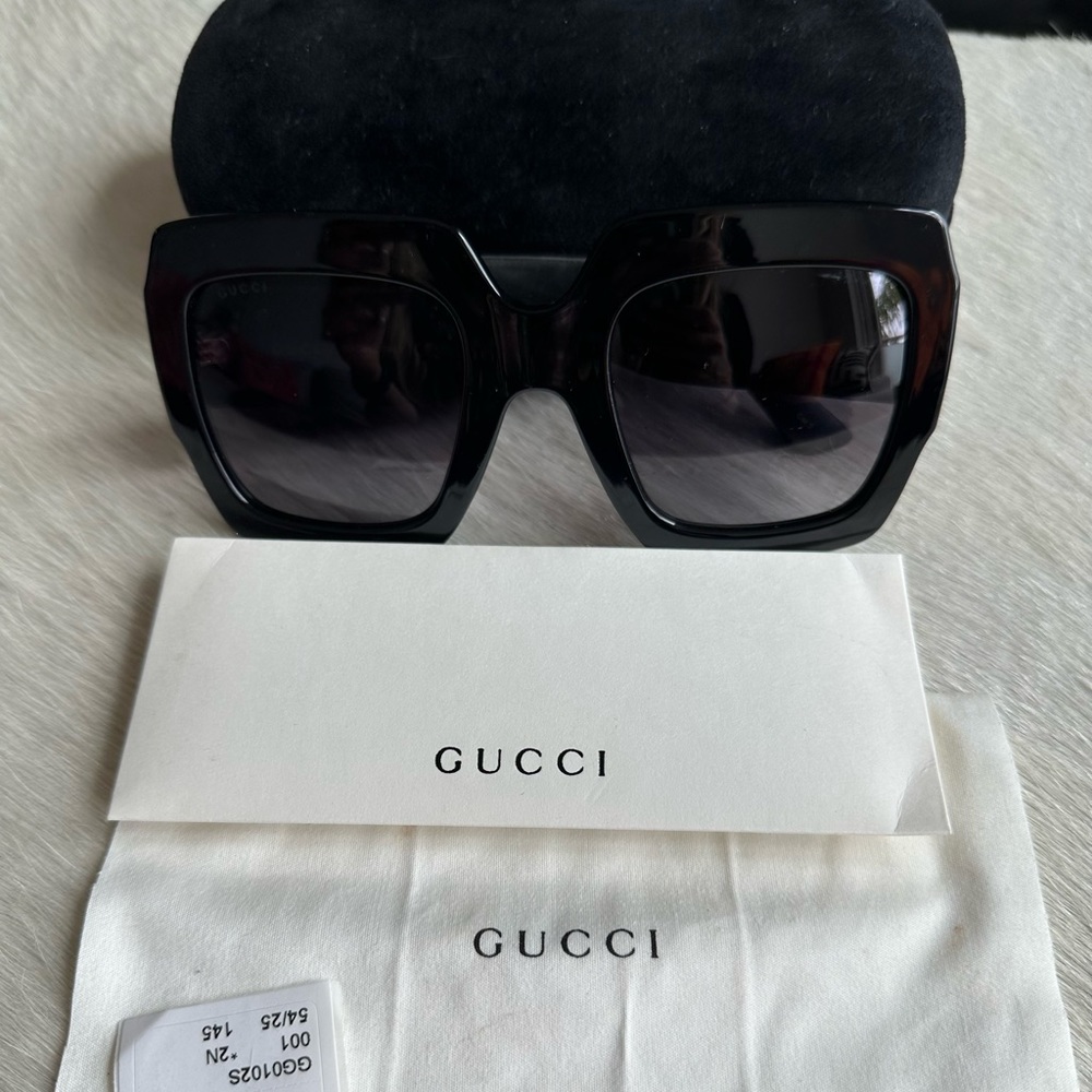 Square-frame sunglasses. The wide temples feature gold intersecting GG logo